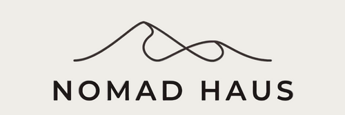Logo of Nomad Haus with a mountain design on a white background