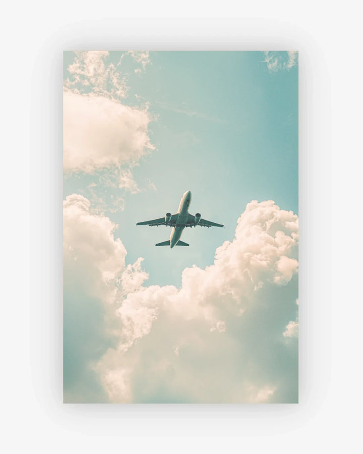 Airplane flying through a cloudy sky with a pastel color palette