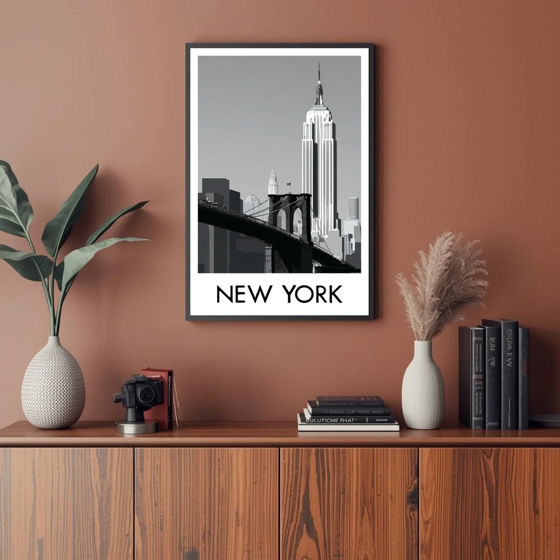 Framed New York cityscape print on a wall above a wooden cabinet with decorative items.