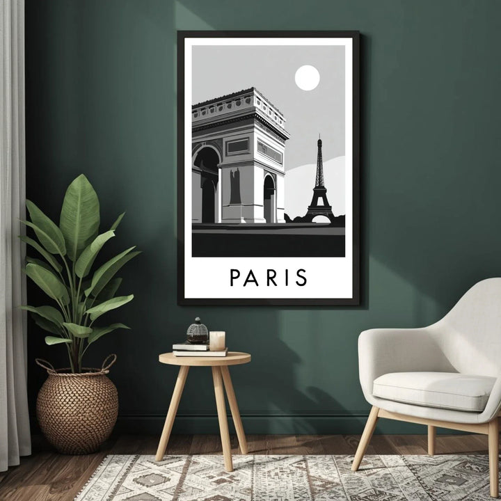 Framed black and white Paris poster on a green wall with a chair and plant in the foreground.