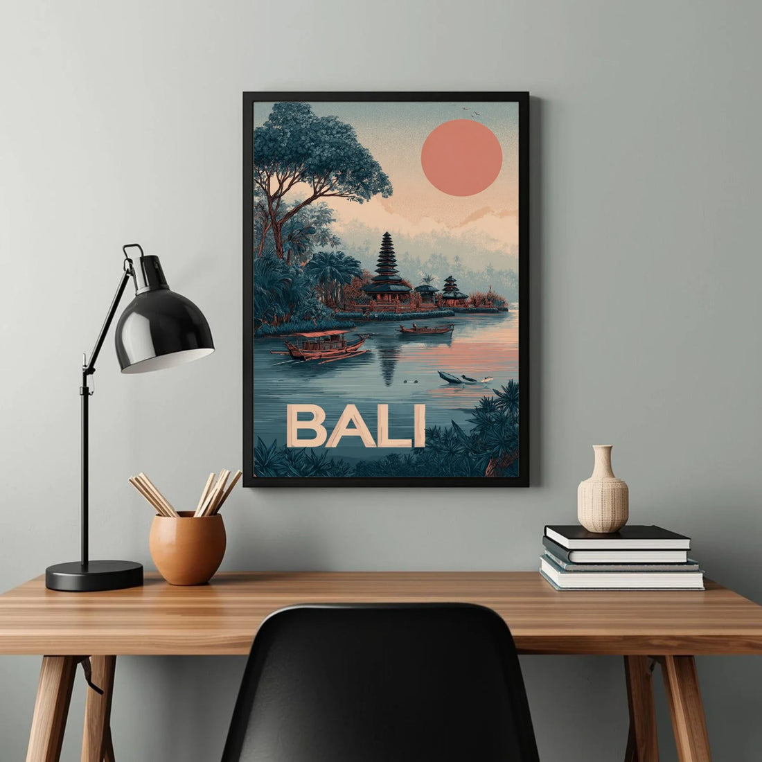 Framed Bali artwork on a wall above a desk with decor items.