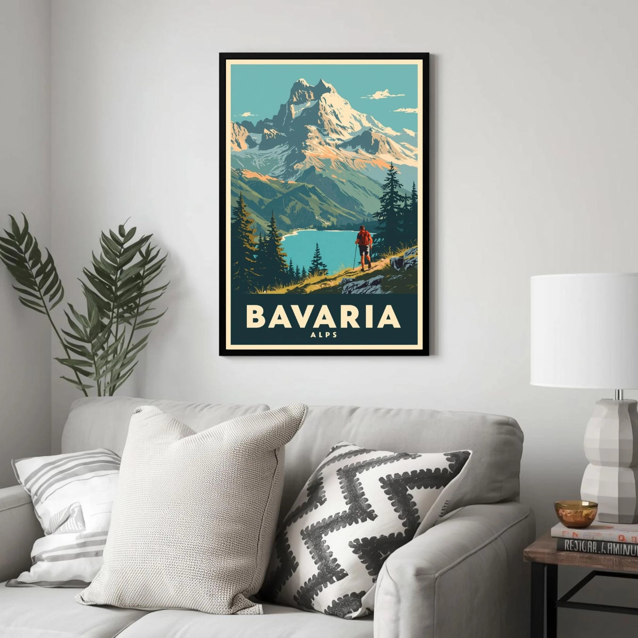 Poster of Bavaria Alps on a wall above a sofa with decorative pillows.