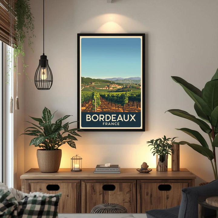 Framed Bordeaux, France poster on a wall above a wooden cabinet with plants and decor.