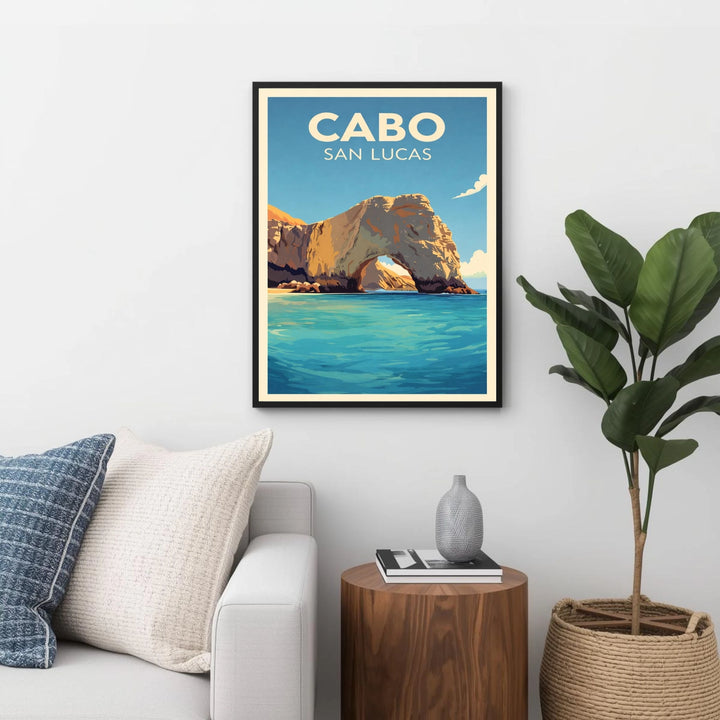 Framed artwork of Cabo San Lucas with a scenic view on a wall above a sofa.