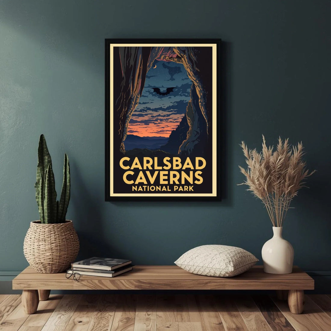 Framed poster of Carlsbad Caverns National Park on a wall above a wooden shelf with decor items.