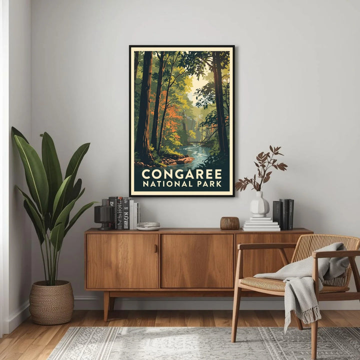 Framed Congaree National Park poster on a wall above a wooden sideboard with books and decor.