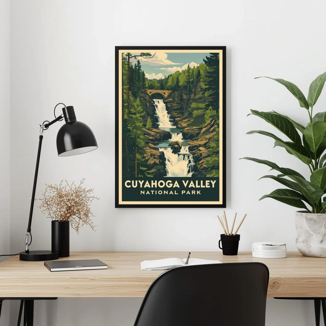 Framed Cuyahoga Valley National Park poster on a wall above a desk with office items.