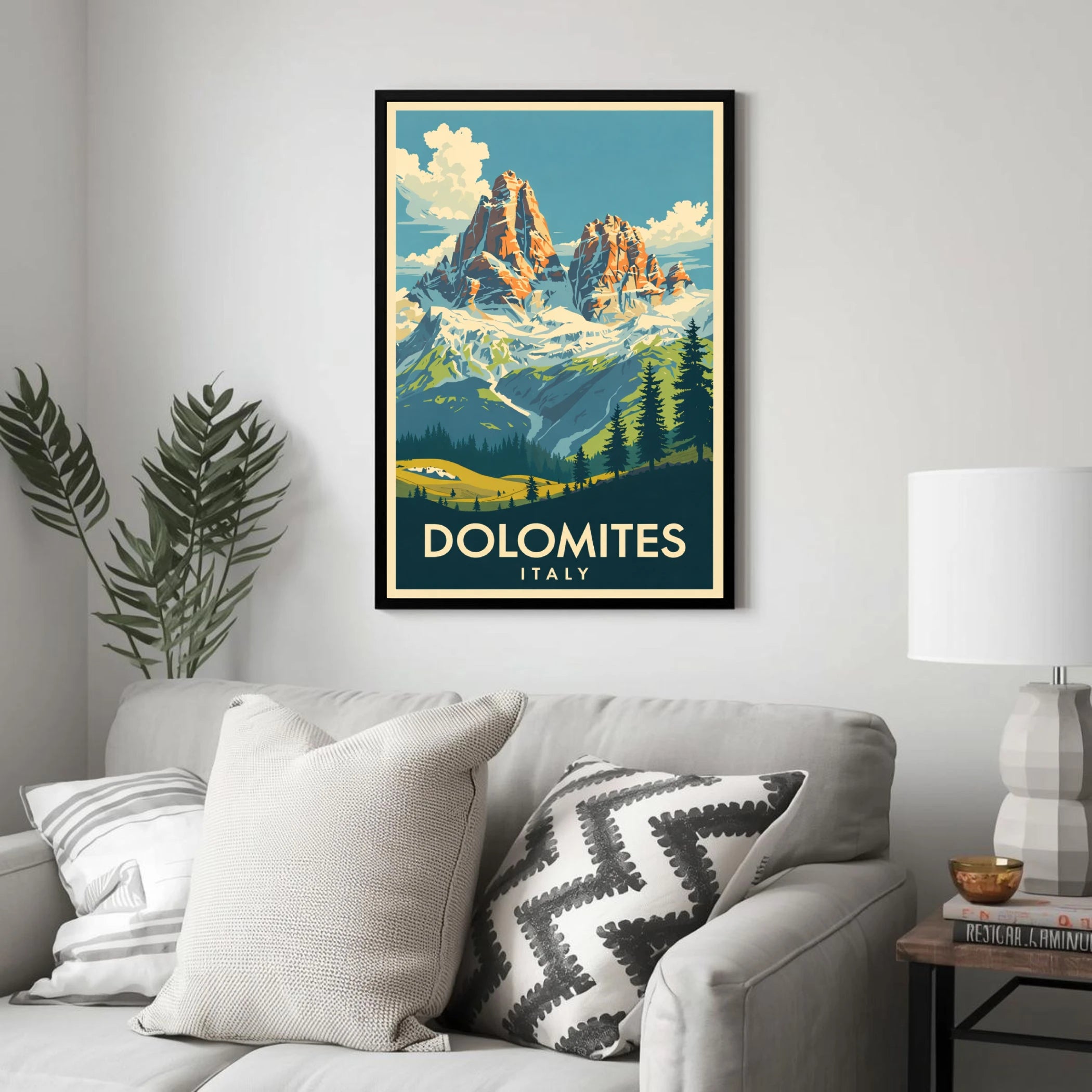 Framed poster of the Dolomites in Italy on a wall above a sofa.