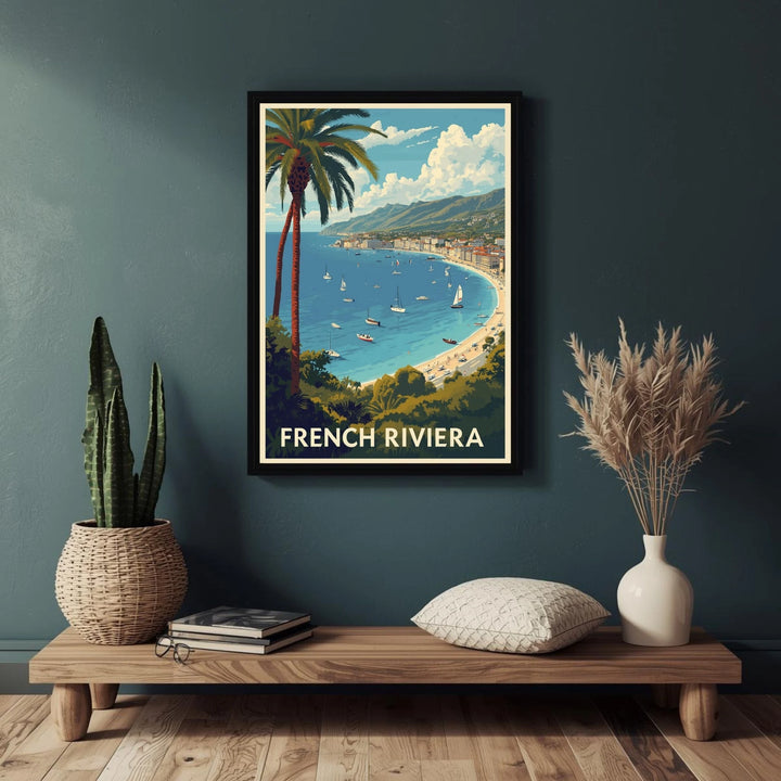 Framed poster of the French Riviera on a wall above a wooden console table with decorative items.