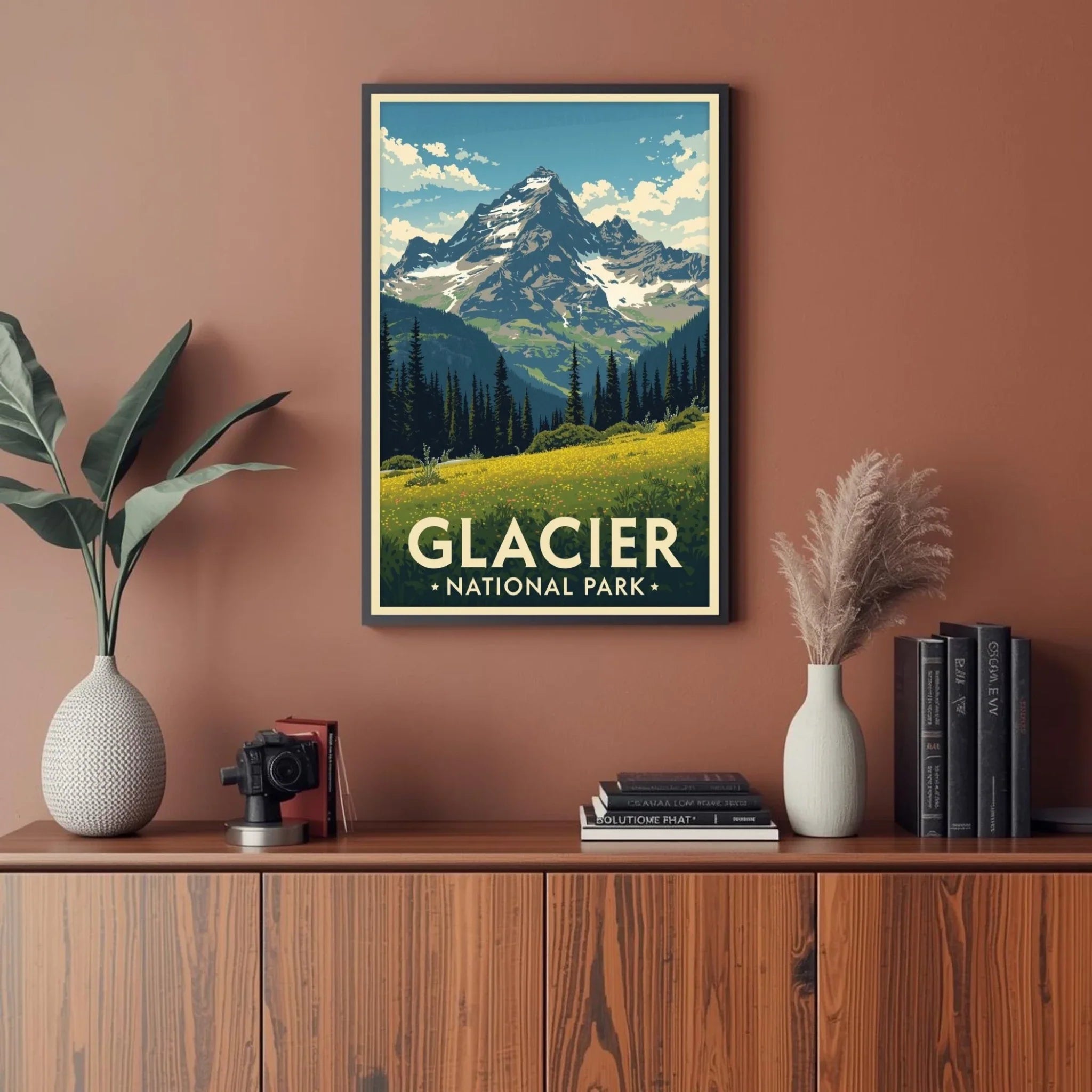 Framed poster of Glacier National Park on a wall above a wooden cabinet with decor items.