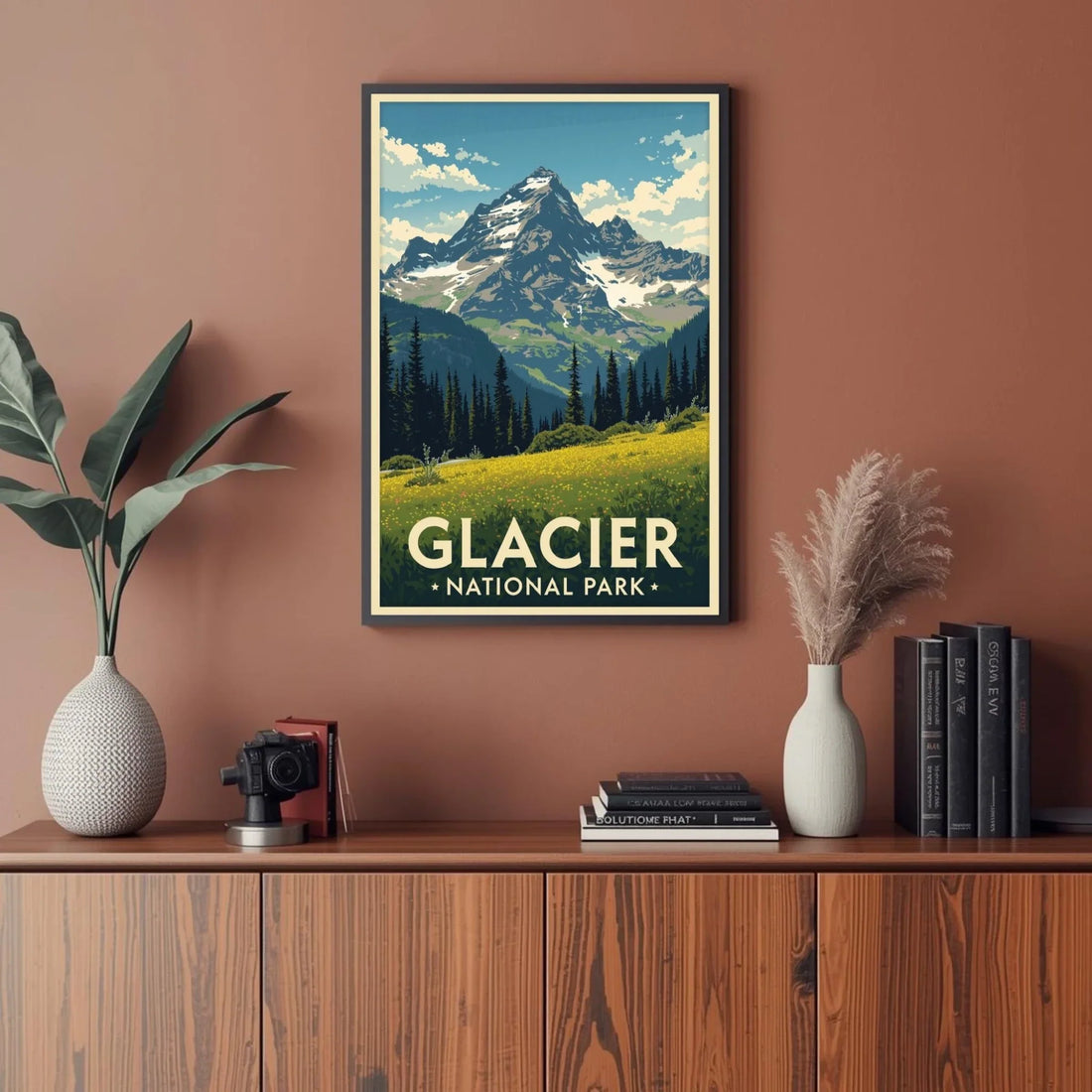 Framed poster of Glacier National Park on a wall above a wooden cabinet with decor items.