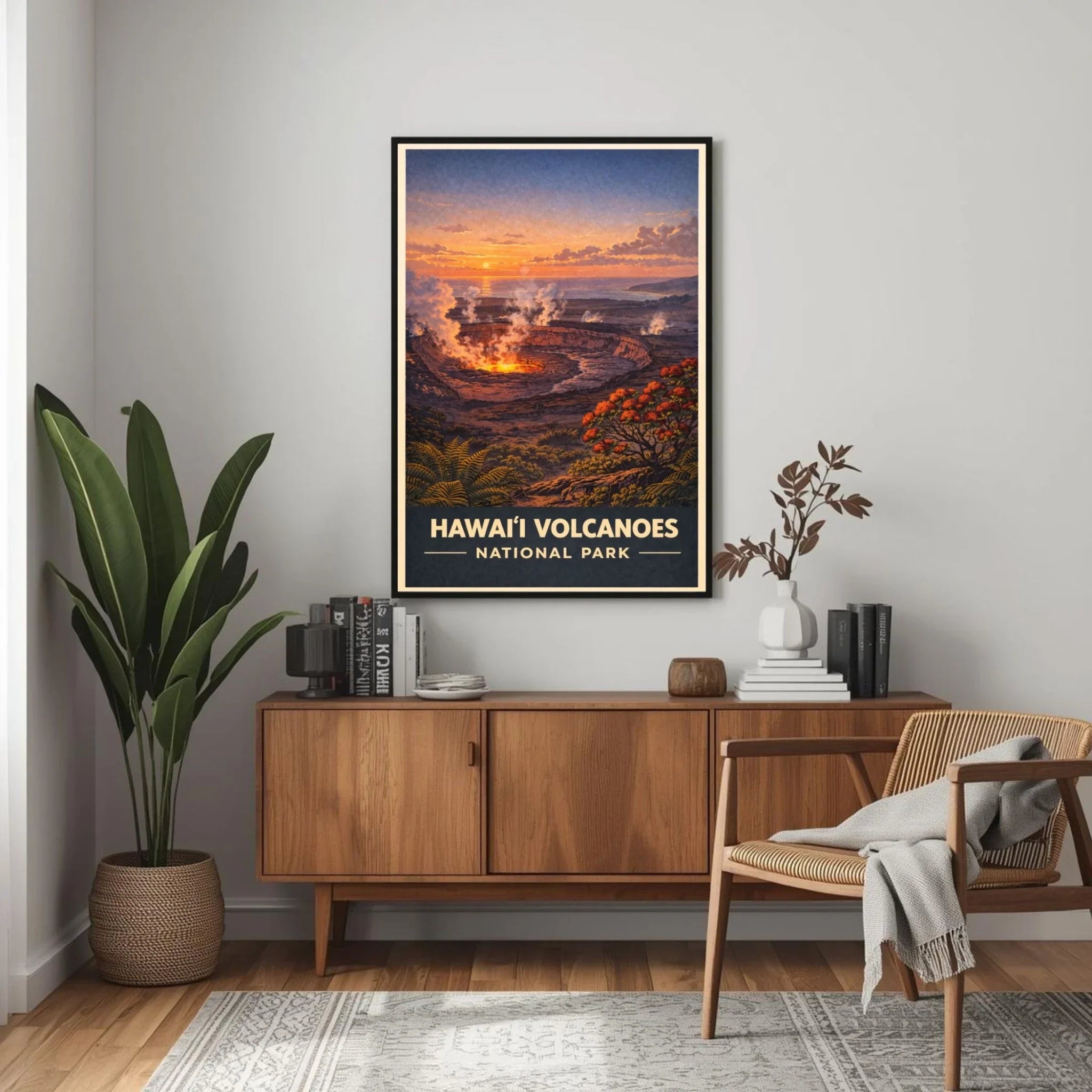 Framed poster of Hawaii Volcanoes National Park above a wooden sideboard in a room with a plant and chair.
