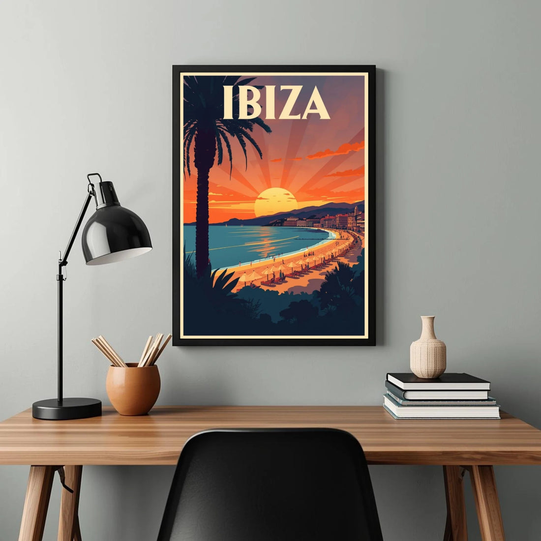 Framed Ibiza artwork on a wall above a desk with decor items.
