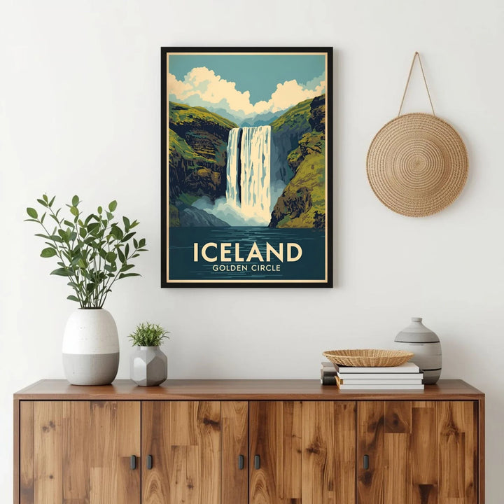 Framed poster of Iceland's Skógafoss waterfall on a wall above a wooden cabinet.