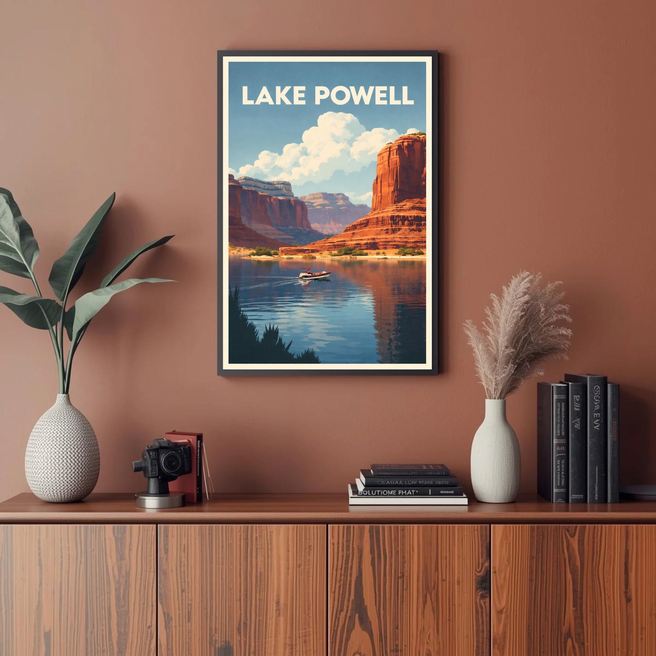 Framed poster of Lake Powell on a wall above a wooden cabinet with decor items.