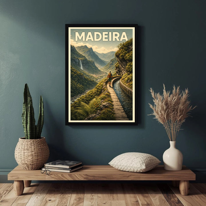 Framed poster of Madeira with a scenic view on a dark green wall above a wooden shelf.