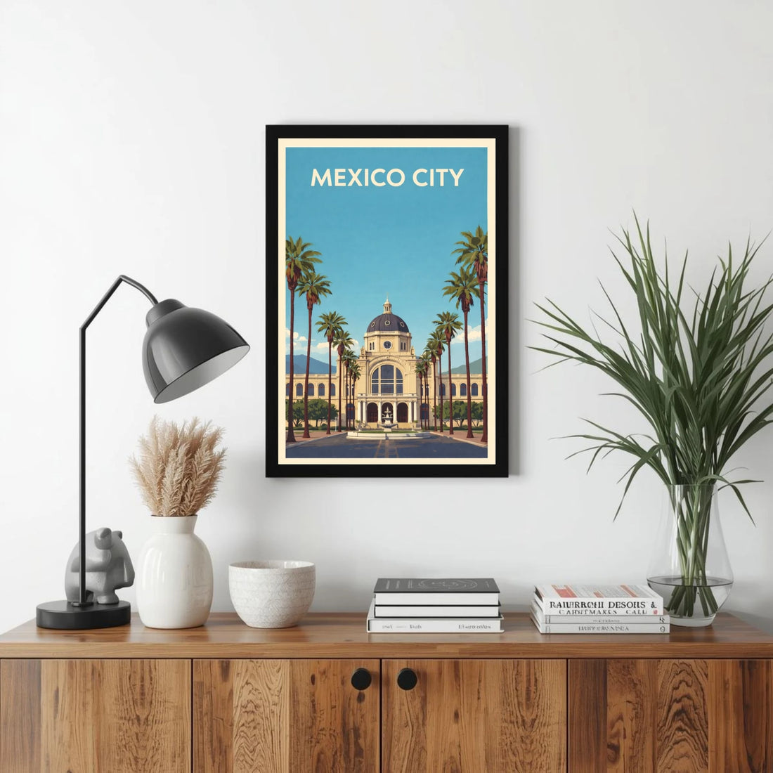 Framed artwork of Mexico City on a wall above a wooden cabinet with decor items.