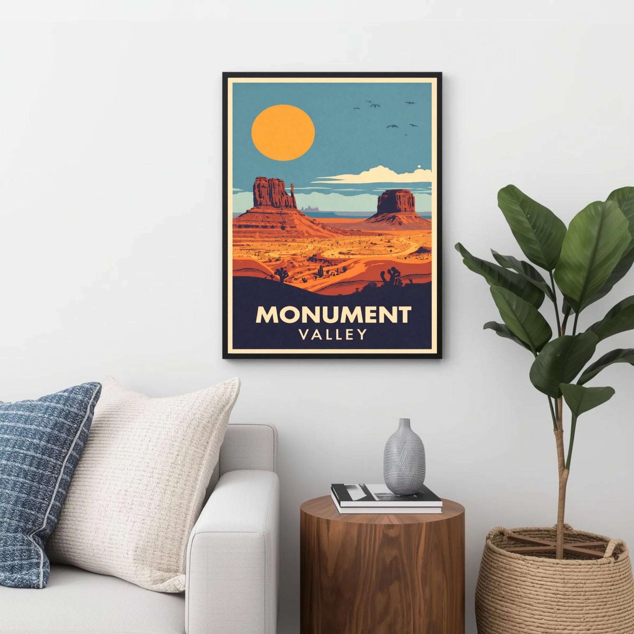 Framed poster of Monument Valley in a living room setting with a couch, plant, and side table.