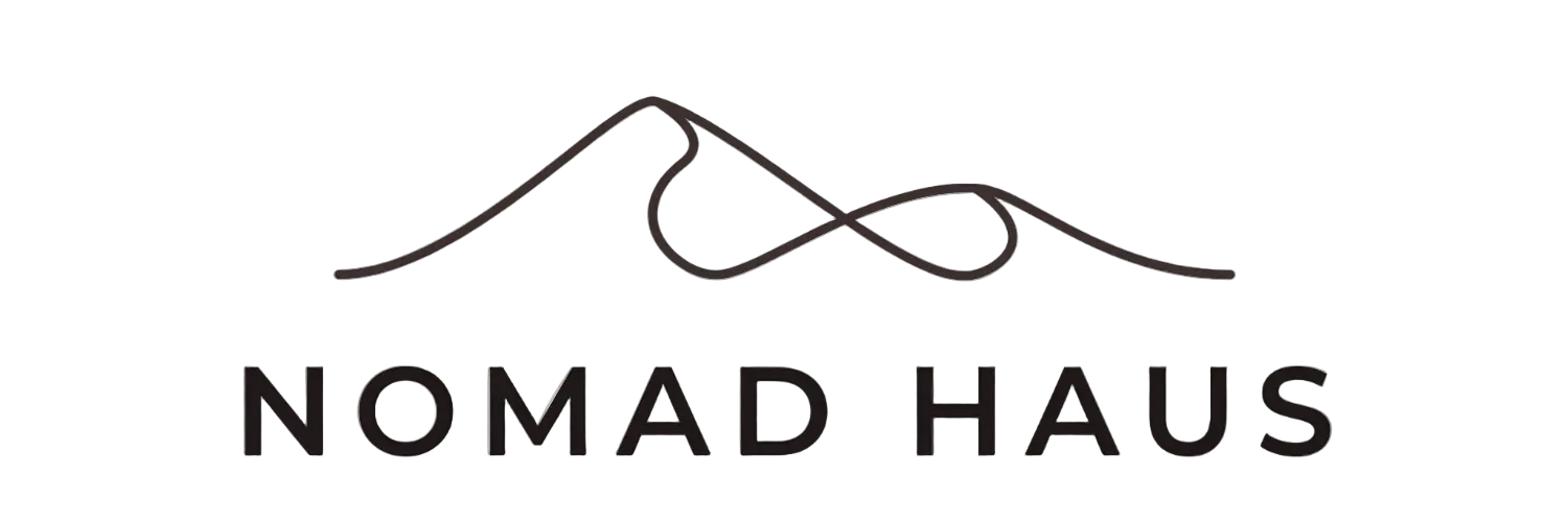 Logo of Nomad Haus with a mountain design on a white background