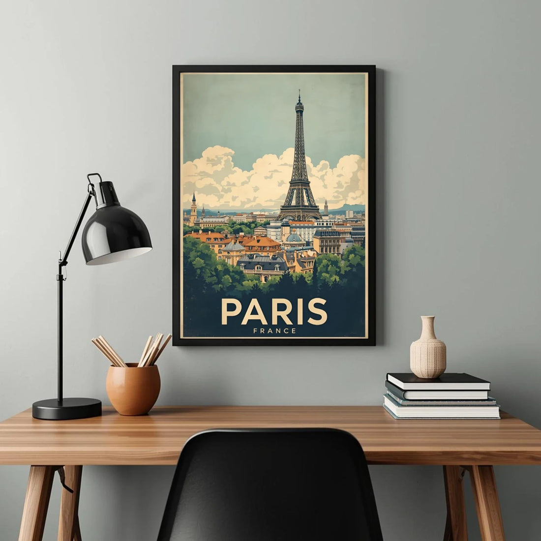 Framed poster of Paris with Eiffel Tower on a wall above a desk.