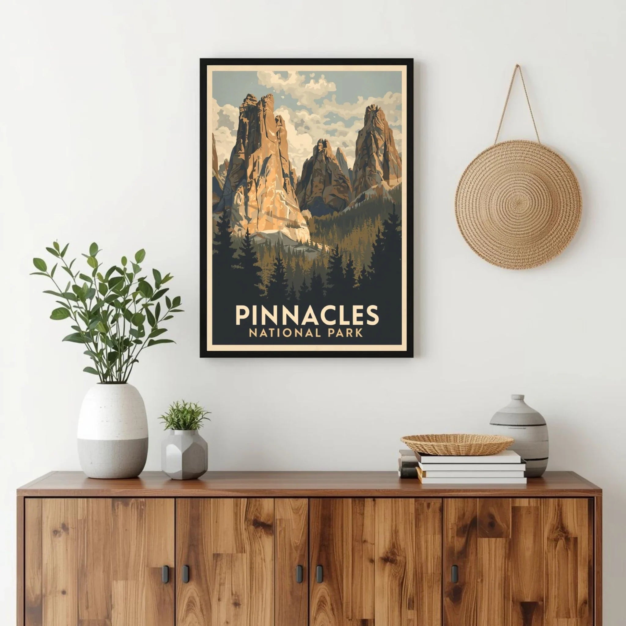 Framed poster of Pinnacles National Park above a wooden cabinet with decorative items.