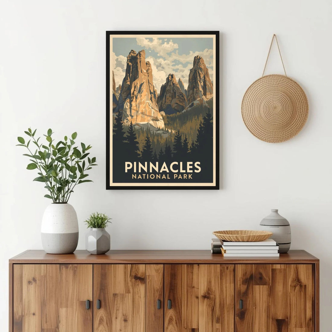 Framed poster of Pinnacles National Park above a wooden cabinet with decorative items.