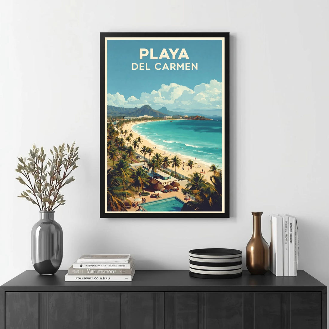 Framed artwork of Playa Del Carmen with a beach scene on a wall above a black console table.