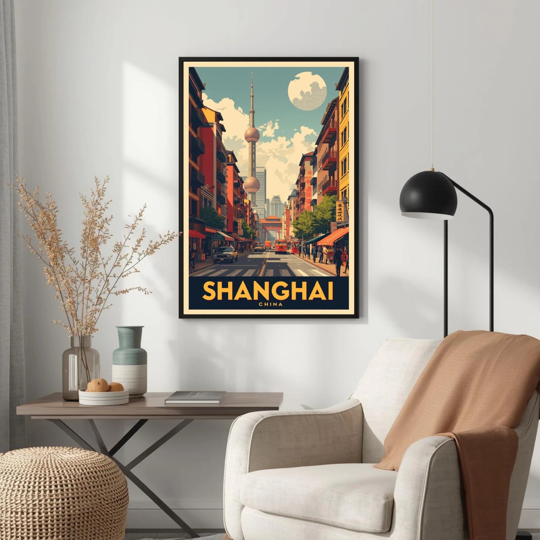 Framed poster of Shanghai on a wall above a chair and table.