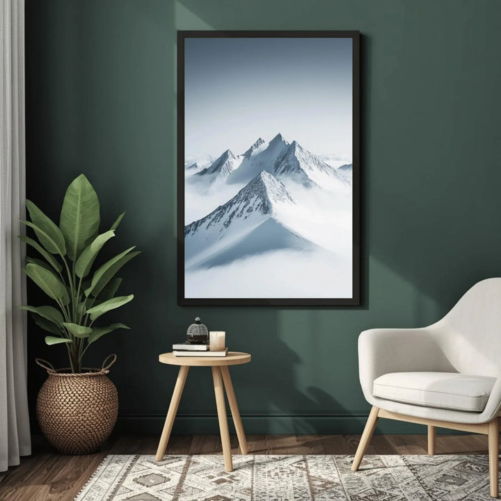 Framed mountain landscape print on a green wall above a small table with decor items.