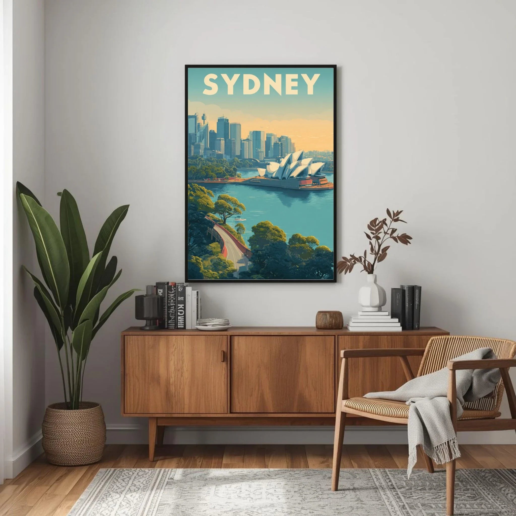 Sydney cityscape poster on a wall above a wooden cabinet with books and decor.