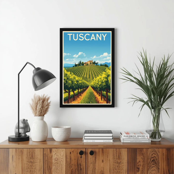 Framed artwork of Tuscany on a wall above a wooden cabinet with decor items.
