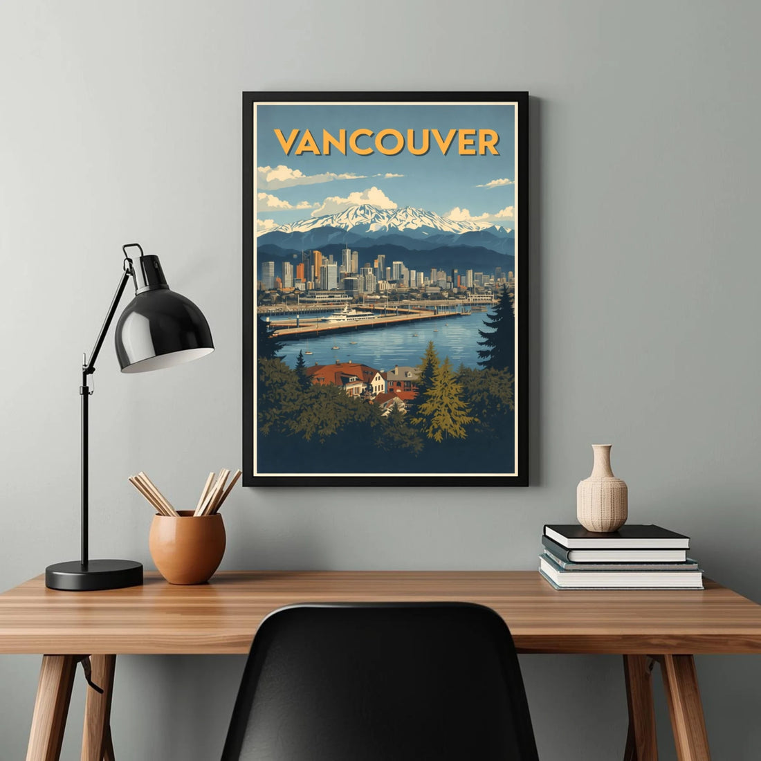 Framed poster of Vancouver on a wall above a desk with decor items.