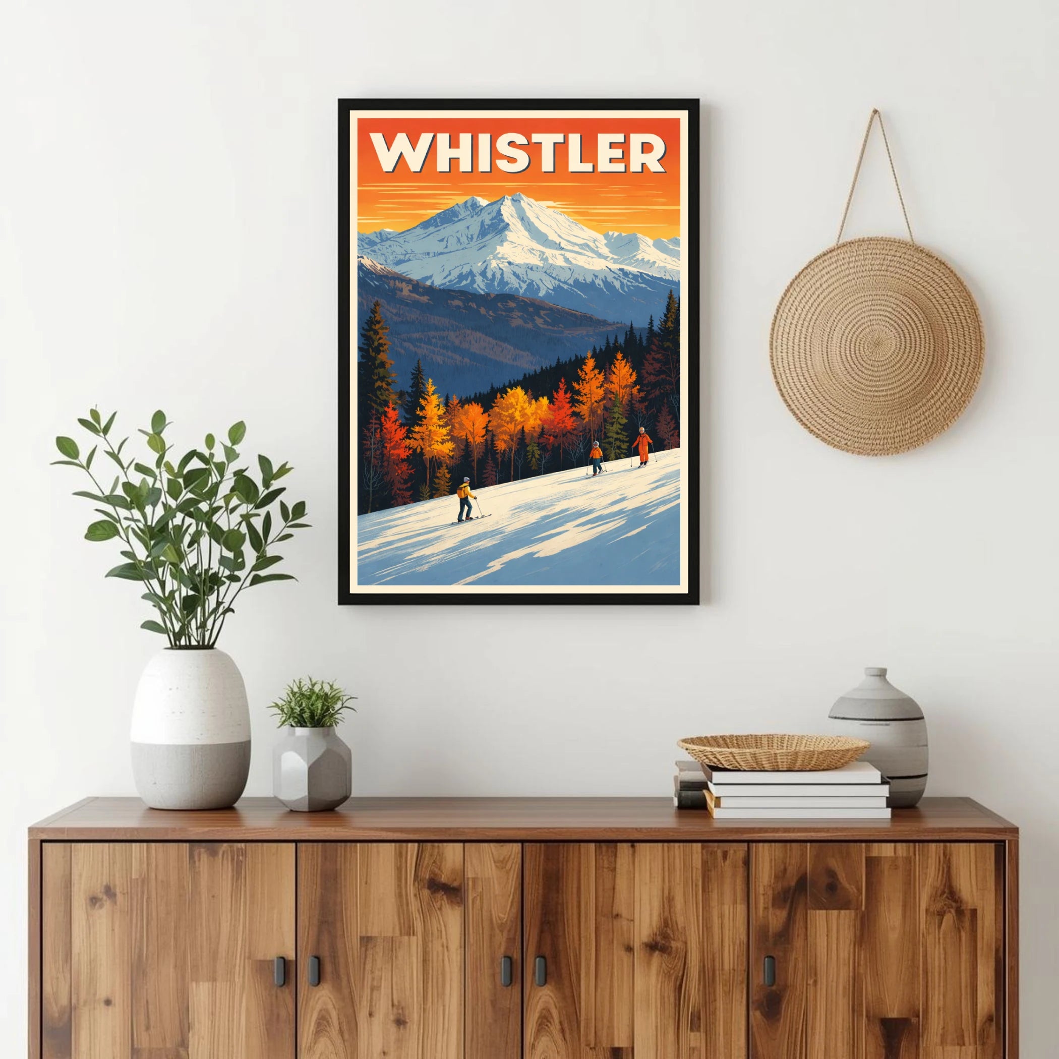 Framed Whistler poster on a wall above a wooden cabinet with decorative items.