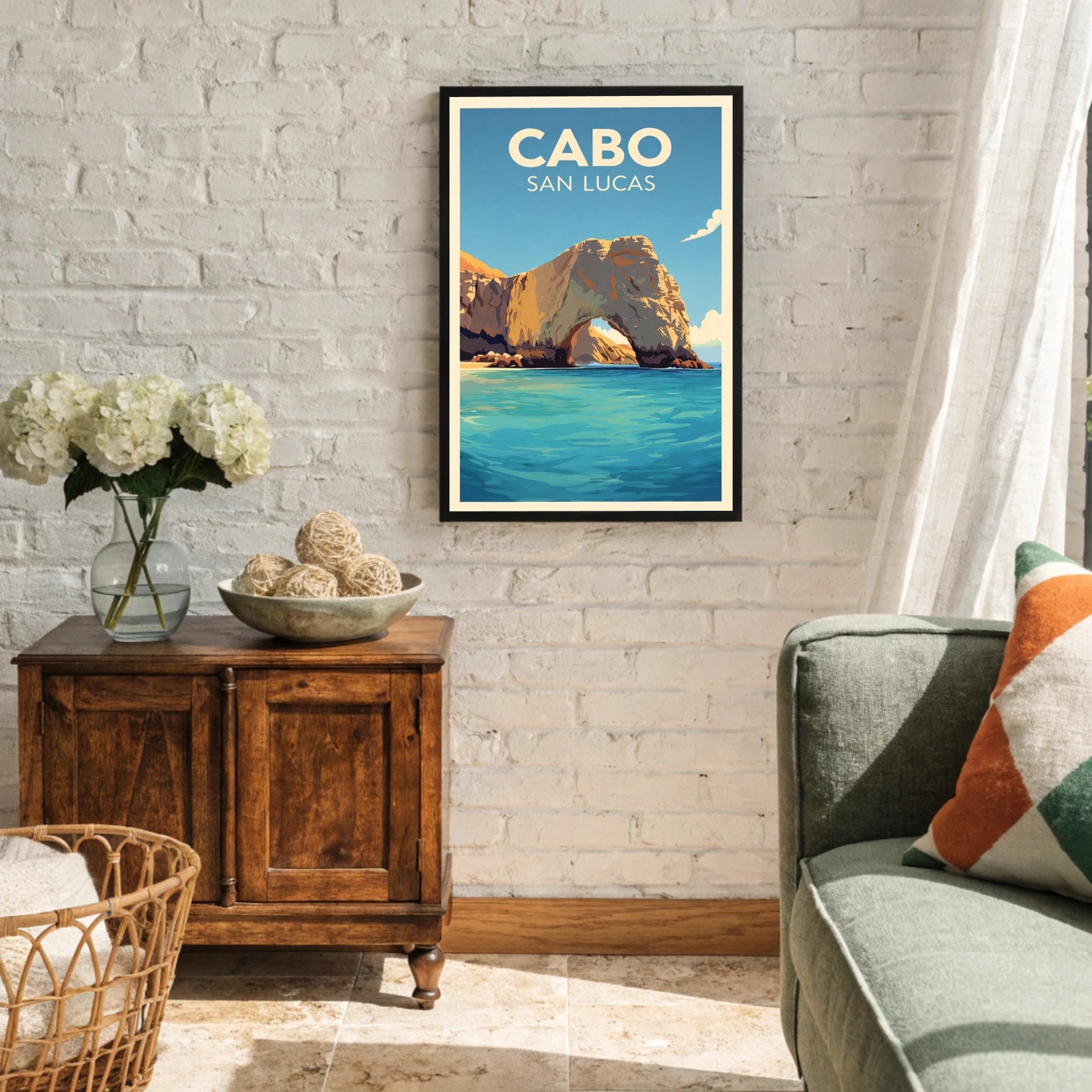 Framed artwork of Cabo San Lucas on a wall in a living room.