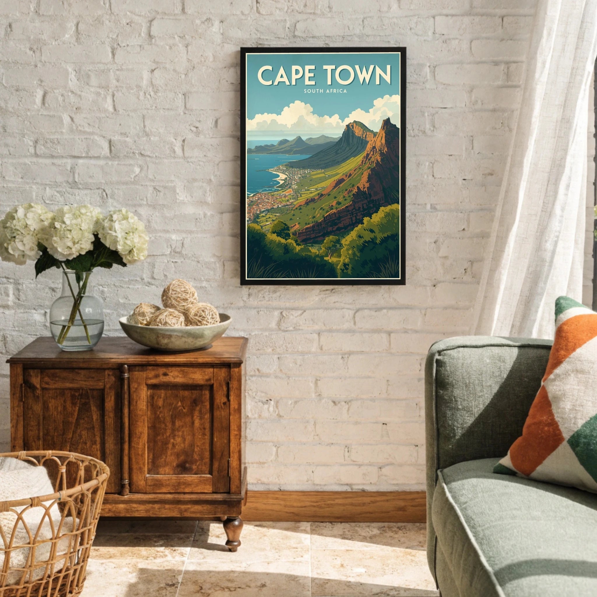 Living room with a framed poster of Cape Town on the wall, wooden cabinet, and sofa.