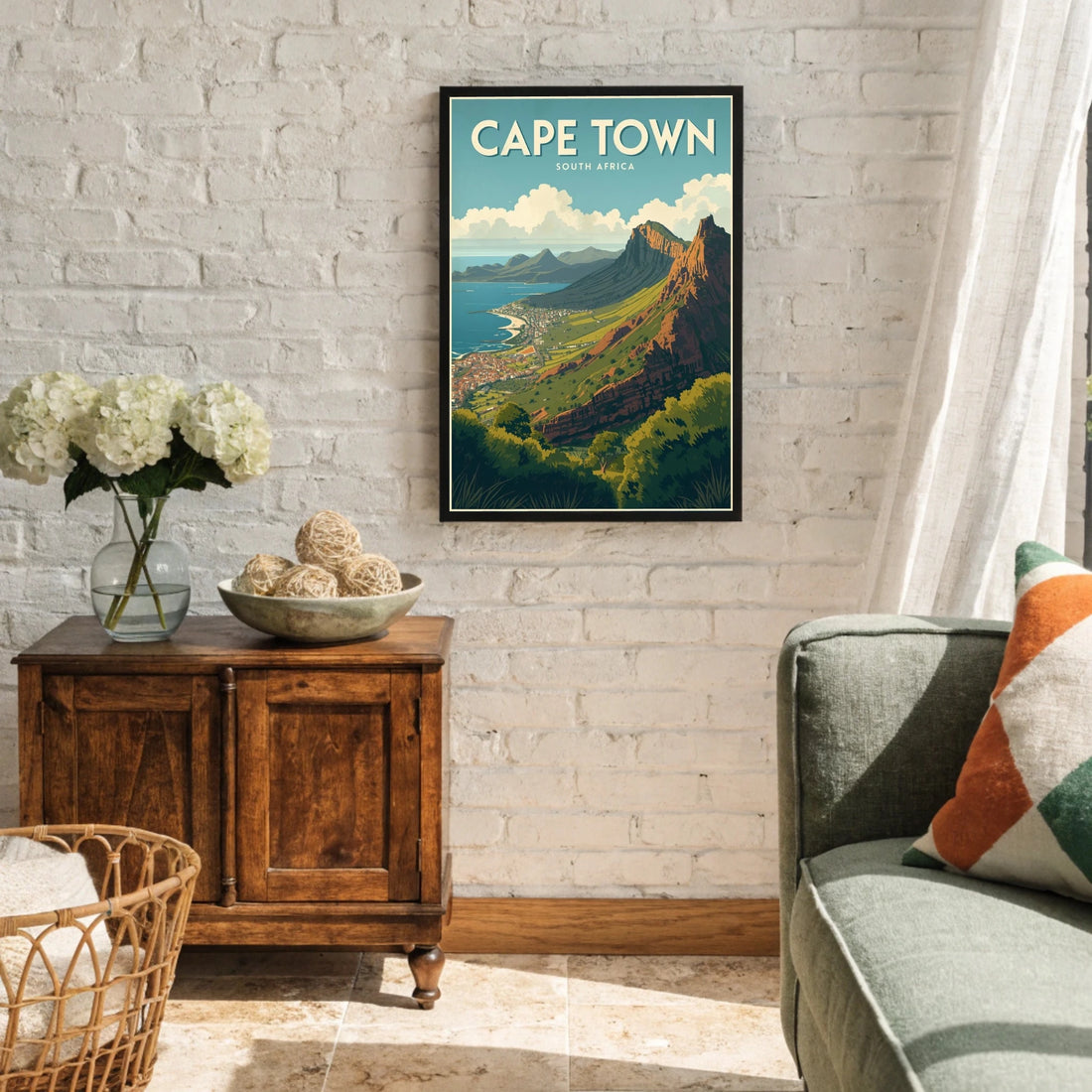 Living room with a framed poster of Cape Town on the wall, wooden cabinet, and sofa.
