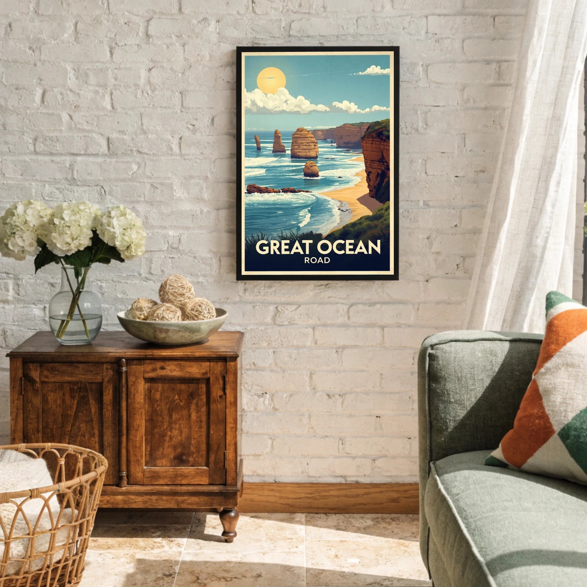 Living room with a framed poster of Great Ocean Road, wooden cabinet, and gray sofa.