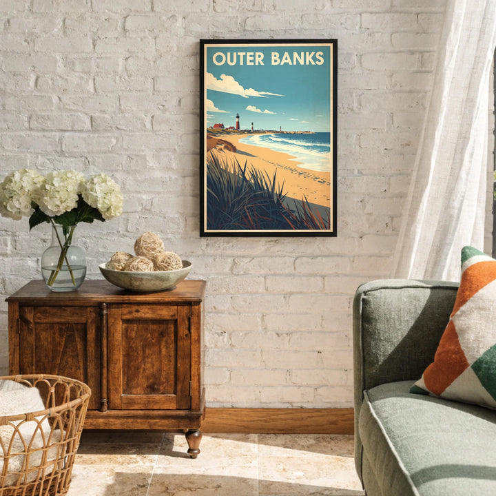 Living room with a framed Outer Banks poster on the wall, wooden sideboard, and gray sofa.