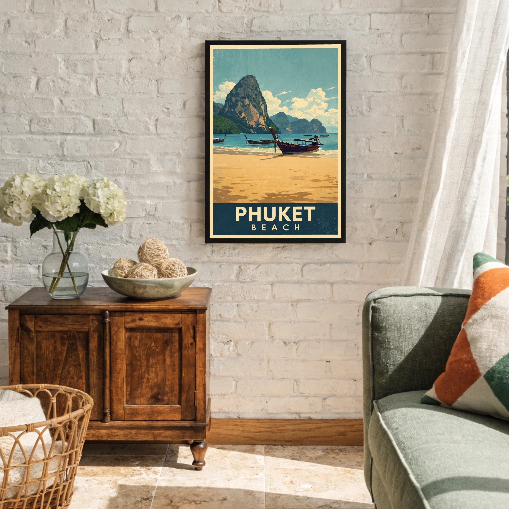 Framed poster of Phuket Beach in a living room setting with a wooden cabinet and decorative items.