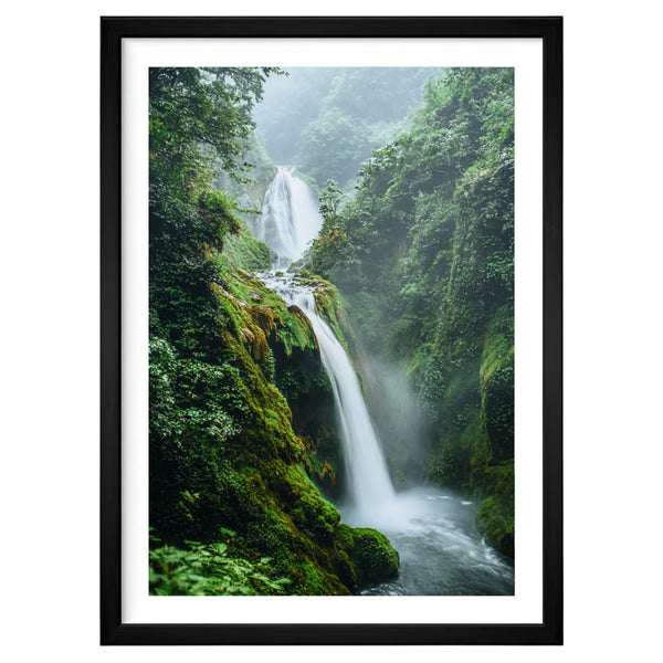 Emerald Falls nature artwork in a black frame leaning against an off-white wall, featuring a cascading waterfall surrounded by lush moss-covered cliffs and soft green mist.