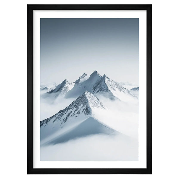 Silent Peaks minimalist mountain artwork in a black frame leaning against an off-white wall, featuring snow-covered peaks rising through soft mist and pale sky gradients.